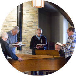 People gather around the piano in Heubach chapel to sing hymns.